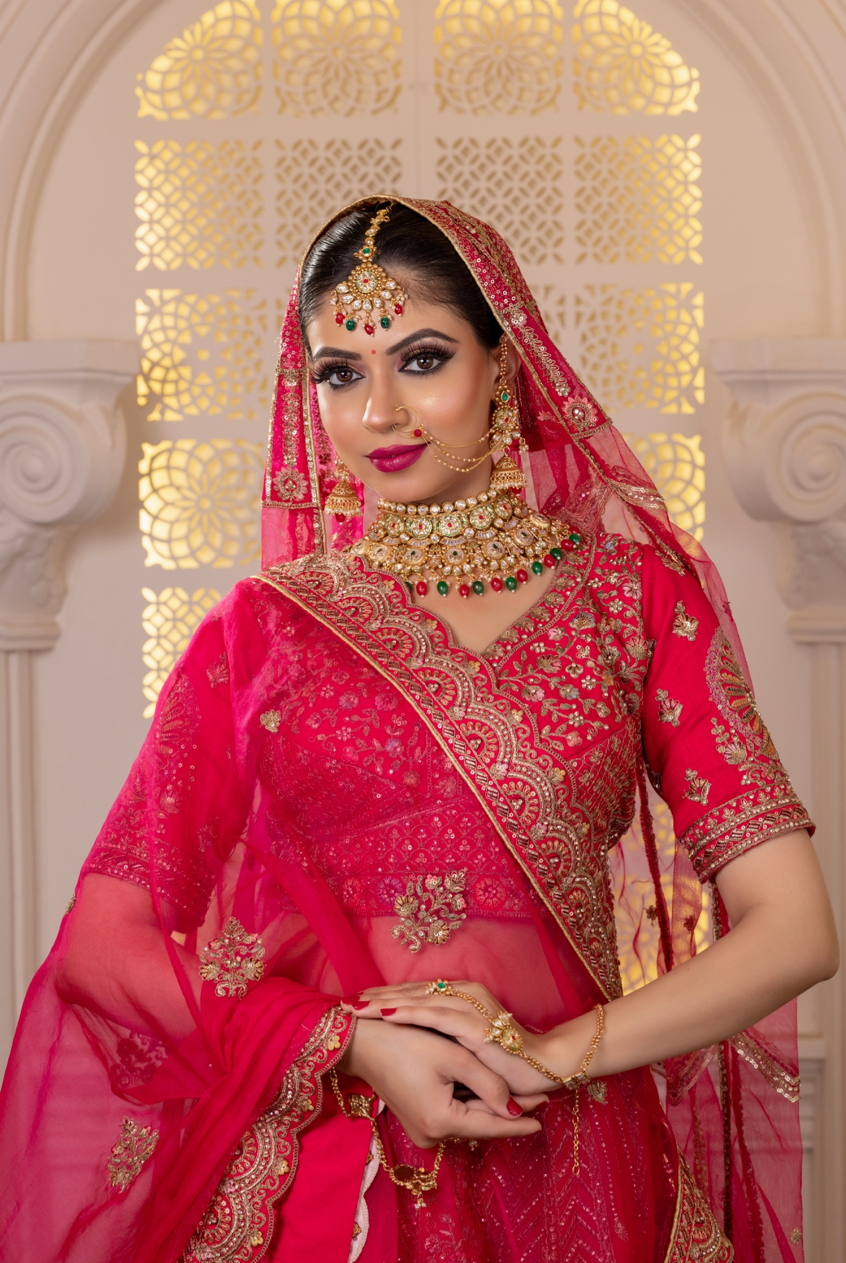 Elegant South Asian bridal makeup with gold jewelry coordination